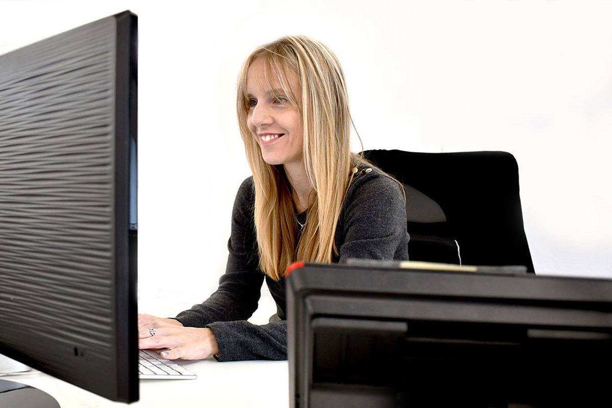 A woman working on her desktop computer